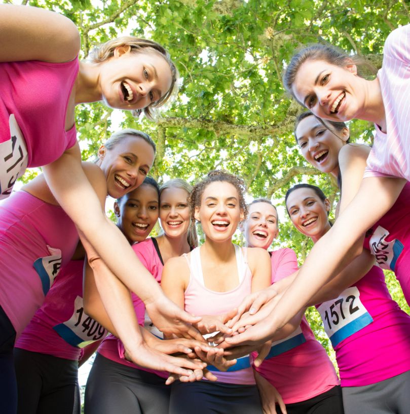 Photo capturing a group of women in pink shirts at a breast cancer awareness event